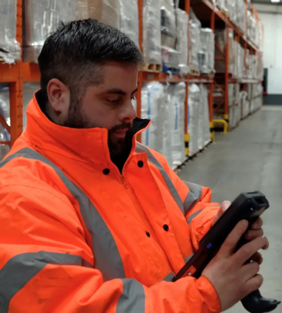 Dale from campeys of selby using a handheld scanner device in the warehouse