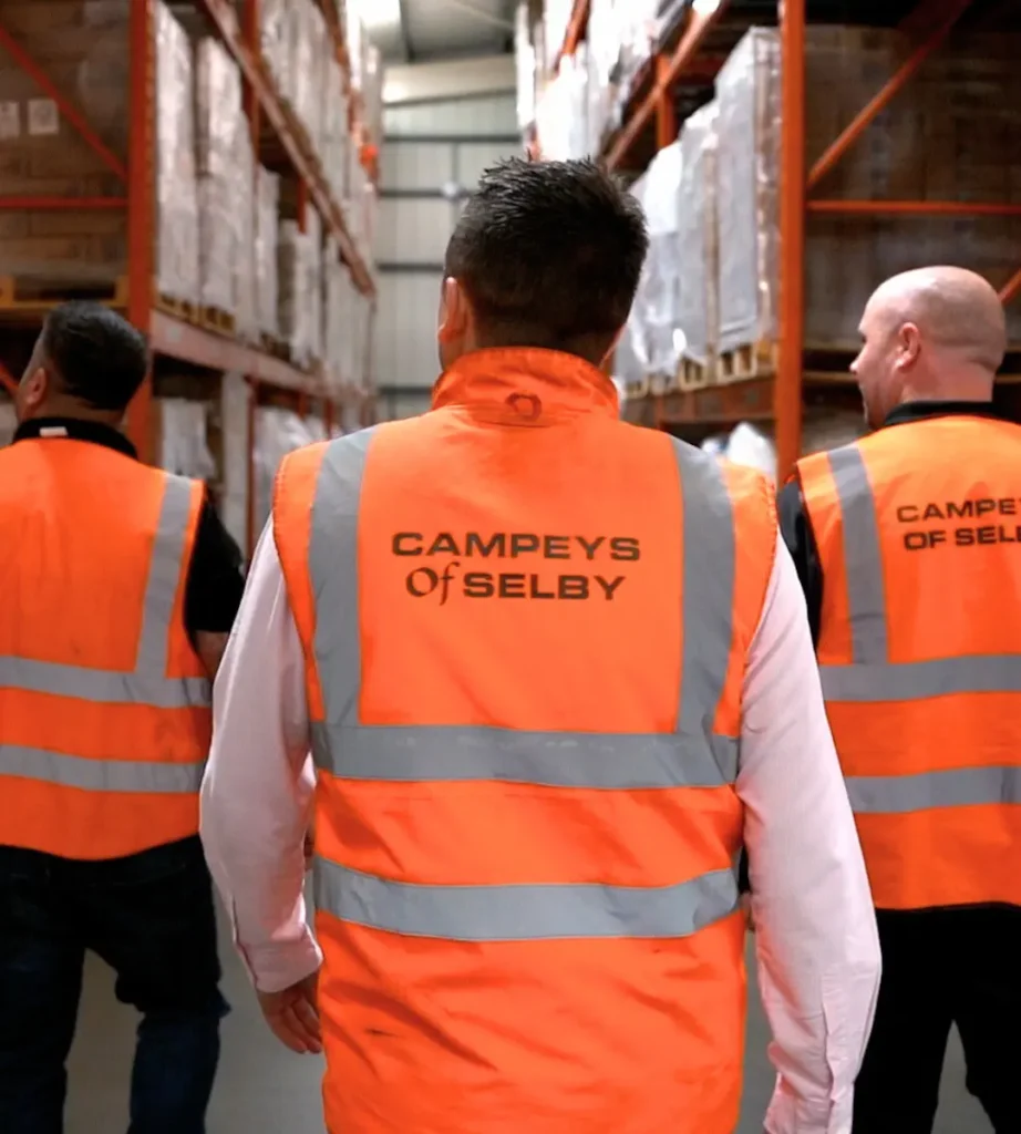 Campeys of selby team members in hi-vis vests walking through their warehouse