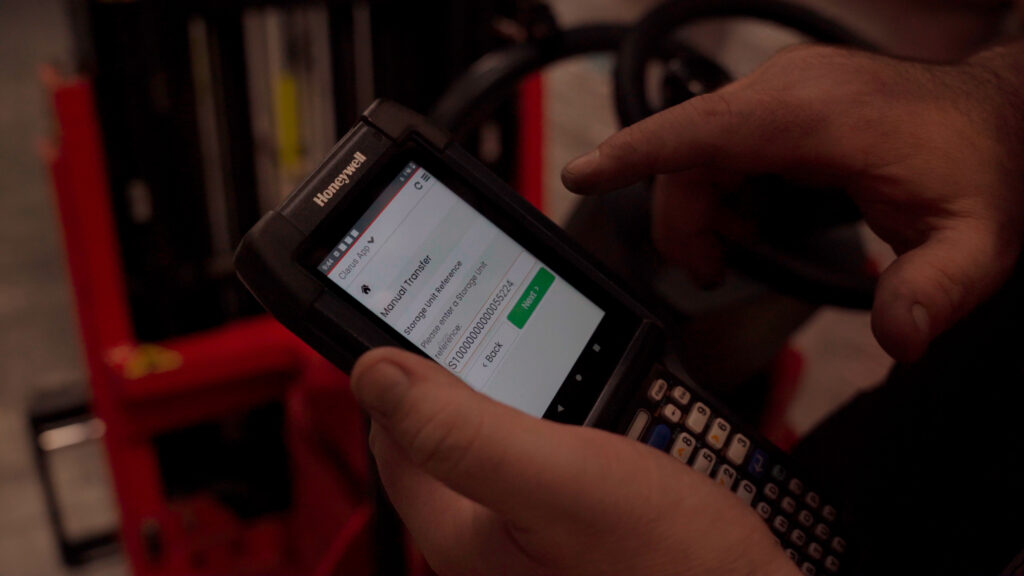 Handheld 2 | clarus wms Warehouse operative entering a storage unit reference in the clarus app on a honeywell handheld scanner